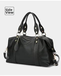 Side view of black lychee grain leather tote bag with gold hardware and removable strap
