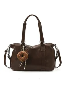 Deep brown large capacity leather travel bag with adjustable strap and donut charm detail