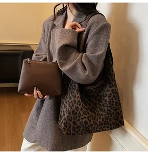Detailed close-up of leopard print tote bag with brown leather pouch for commute
