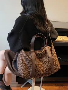 Minimalist leopard print tote bag with brown faux leather handles for travel and daily use