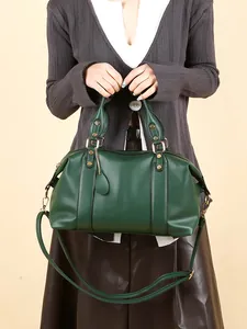Elegant dark green leather Boston bag with gold hardware and adjustable strap for women