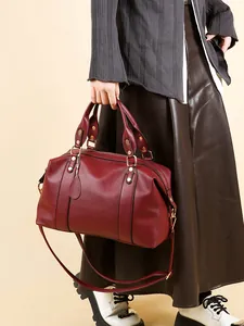 Burgundy lychee pattern leather Boston bag with gold hardware and dual carry straps