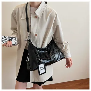Detail of glossy black pleated leather bag with silver zipper and Lazy breeze tag