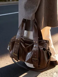 Maillard punk style dark brown retro motorcycle tote bag with golden studs on city road