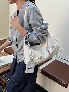 Chic cream white underarm shoulder bag with textured leather and knot strap design