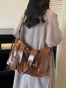 Vintage brown leather tote bag with punk belt buckles and wide adjustable shoulder strap
