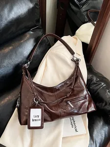 Brown faux leather shoulder bag with vintage oil-wax finish and designer card holder tag