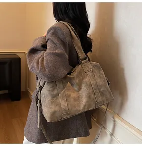 Detail view of large grey tote bag in vintage oil wax leather with adjustable shoulder strap