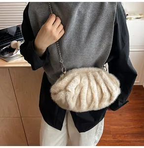 Detail of cream plush cloud bag with soft faux fur texture and silver metal chain strap