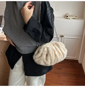 Detail of soft plush cloud bag with elegant silver chain strap in cream white