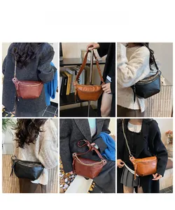 Detail showing various colors of the crescent moon crossbody bag with metal chain