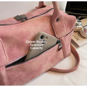 Pink suede-like travel tote detail showing a functional side zipper pocket for phone storage