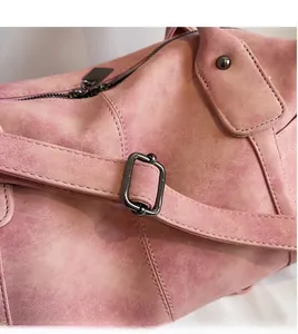 Detail of pink retro textured tote bag with adjustable shoulder strap and metal buckle
