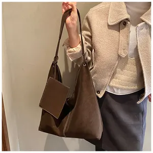 Detail of dark brown faux suede tote bag with white stitching and matching coin purse