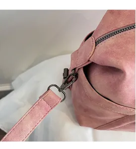 Close-up of durable gunmetal rotating hook and detachable strap on pink travel bag