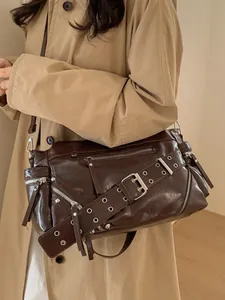 Vintage brown oiled leather crossbody bag with multiple zippers and industrial metal buckles