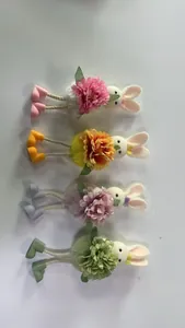 Detail of colorful Easter bunny plush hanging ornaments with floral decor and rope legs