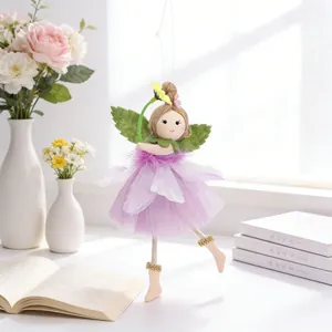 Detail of flower fairy doll with purple tulle skirt, daisy headband, and green leaf wings