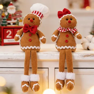 Detail of Christmas gingerbread plush dolls with long legs on festive tabletop
