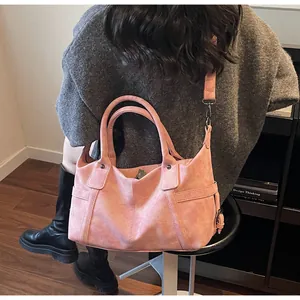 Detail of pink vintage crossbody bag showing matte texture and gunmetal hardware