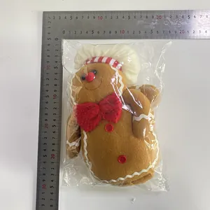 Detail of Christmas gingerbread man plush with chef hat in clear plastic packaging