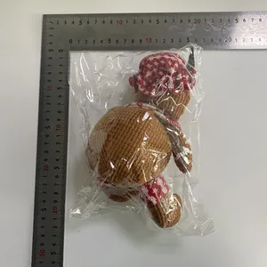 Gingerbread man plush ornament measuring 18-20cm with festive hat and scarf detail