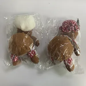 Detail of Christmas gingerbread chef plush ornaments packed in clear protective bags