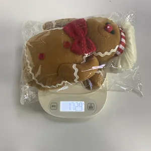 Detailed view of long-legged gingerbread man plush toy weighing 172.9g on a scale