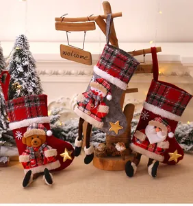Detailed view of Christmas stockings with 3D bear, snowman and Santa Claus plush hanging legs