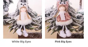 Close-up of cute plush Christmas angel dolls in white and pink outfits with owl hats