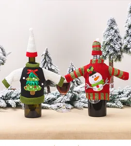 Detail of Christmas wine bottle covers featuring mini knit sweaters and snowman patterns