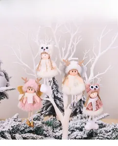 Detail showing plush Christmas angel doll ornaments with faux fur and bell decorations
