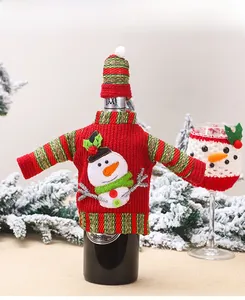 Detail of red knit snowman wine bottle cover and mini hat for Christmas table decor