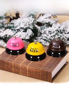 Three creative metal service bells with HUG, BEER, and Coffee labels on a black base