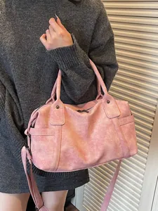 Pink vintage textured Boston handbag shown on model for a stylish casual commuter look