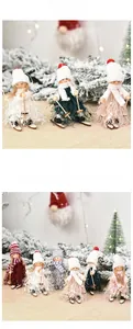 Detailed view of handmade Christmas ski dolls with knitted hats and wooden skis on pine branches