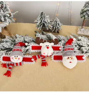 Detailed view of plush Santa, Reindeer, and Snowman curtain tiebacks with lace trim