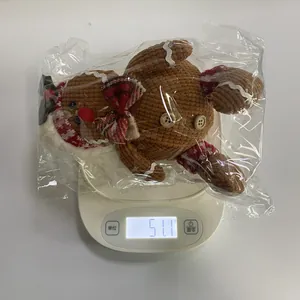 Detailed view of striped corduroy gingerbread man ornament weighing 51.1g on a scale