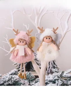 Close-up of pink and white plush angel ornaments with sequin wings on Christmas tree