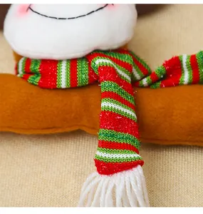 Close-up of a Christmas plush doll featuring a striped knit scarf and soft texture