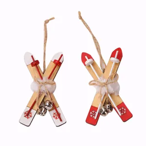 Wooden Christmas sled ornaments with red and white snowflake patterns and silver bells