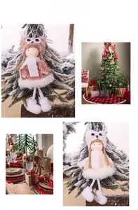 Detail of plush Christmas angel dolls in pink and white used as festive tree ornaments