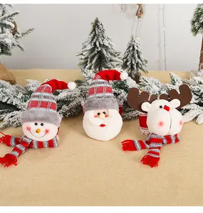 Close-up of plush Santa, Snowman and Reindeer figurines with striped knit hats