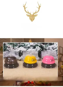 Three colorful metal call bells in gift boxes for coffee, beer, and hug service requests