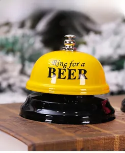 Detail of yellow metal service bell with Ring for a BEER text and festive background