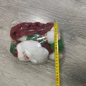 Detailed view of a plush Christmas doll with a long hat, measuring about 20cm in packaging
