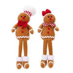 Pair of plush Christmas gingerbread dolls with long legs and festive chef hats ornaments