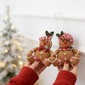 Pair of plush gingerbread man Christmas tree ornaments with chef hats in hand