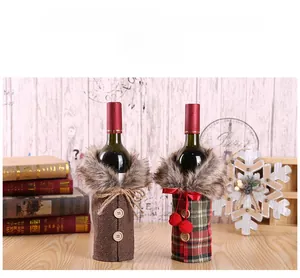 Detail of Christmas wine bottle covers with faux fur collars and festive plaid patterns