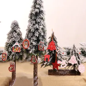 Handcrafted Christmas wooden ornaments set with bells, socks and reindeer on festive trees
